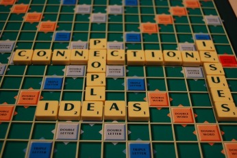 scrabble board with words relating to connections, e.g. ideas, people